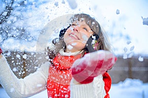 Christmas sale. Beautiful surprised woman in red mitts and white sweater winter background with snow, emotions. Funny laughter wom