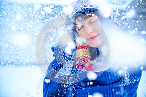 Christmas sale. Beautiful surprised woman in red mitts and white sweater winter background with snow, emotions. Funny laughter wom