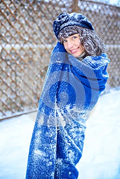 Christmas sale. Beautiful surprised woman in red mitts and white sweater winter background with snow, emotions. Funny laughter wom