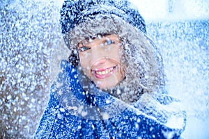 Christmas sale. Beautiful surprised woman in red mitts and white sweater winter background with snow, emotions. Funny laughter wom