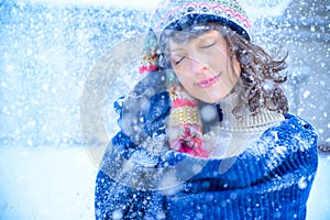 Christmas sale. Beautiful surprised woman in red mitts and white sweater winter background with snow, emotions. Funny laughter wom