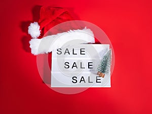 Christmas sale, boxing day lightbox on red with santa cap