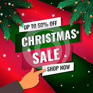 Christmas sale card with pointing hand to shop now and Christmas tree branches and sparkling lights garland photo
