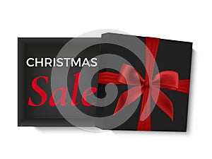 Christmas sale design. Opened black realistic 3d gift box with red ribbon and bow isolated on white background.