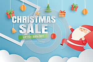 Christmas sale with gifts and elements hanging on red background banner in paper art style