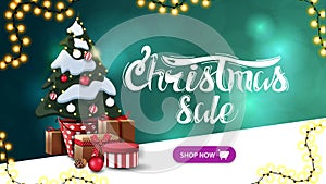 Christmas sale, green discount banner with blurred background, garlands, button and Christmas tree in a pot with gifts