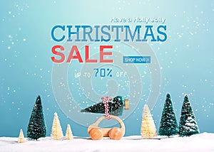 Christmas sale message with car carrying a Christmas tree