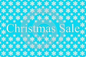 Christmas sale and snowflakes on a blue background, top view. Background for new year and winter sales. Seasonal discounts in