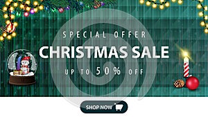 Christmas sale, up to 50% off, green horizontal modern web banner with button, garland, candle and snow globe with snowman