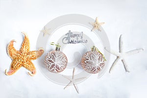 Christmas sand beach background, Christmas-tree decoration ball with starfish at ocean beach, Xmas and New Year holiday vacation