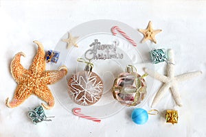 Christmas sand beach background, Christmas-tree decoration ball with starfish at ocean beach, Xmas and New Year holiday vacation