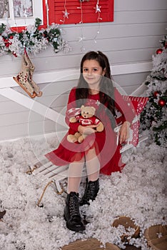 Christmas Santa. Beautiful smiling woman model. Healthy long hair style. lady in red dress. happy new year