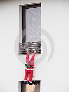 Christmas Santa Claus climbing to the window