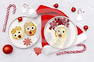 Christmas Santa Claus,deers face shaped pancake with fresh raspberry berry,cheese on plate for kids baby children breakfast dinner