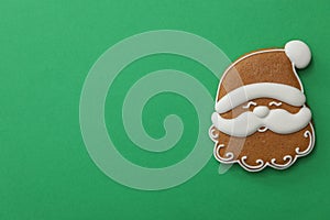 Christmas Santa Claus face shaped gingerbread cookie on background, top view. Space for text