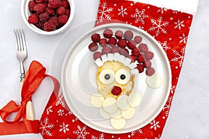 Christmas Santa Claus face shaped pancake raspberry,cheese on plate for kids baby children breakfast dinner. xmas food with new
