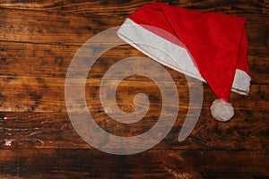 Christmas Santa Claus Hat On Dark Grunge Wooden Background., Xmas or Happy New Year Concept