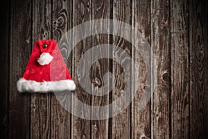 Christmas Santa Claus Hat Hanging On Wood Wall