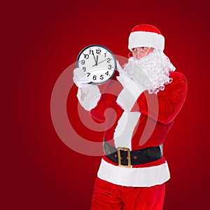 Christmas Santa Claus pointing at clock showing five minutes to midnight