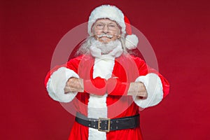 Christmas. Santa Claus with red bandages wound on his hands for boxing imitates kicks. Kickboxing, karate, boxing