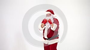 Christmas. Santa Claus on a white background in red bows for boxing and kickboxing fulfills blows. The image of a