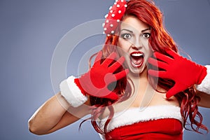 Christmas Santa hat redhair woman portrait .