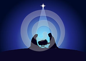 Christmas scene of baby Jesus in the manger with Mary and Joseph in silhouette