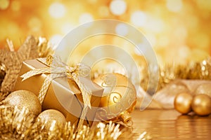 Christmas scene with gold baubles and gift, gold background