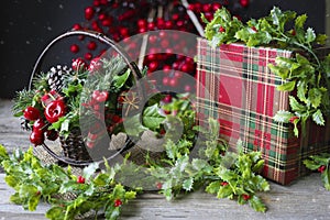 Christmas scene of holly and cranberries and  checkered box
