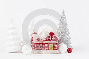 Christmas scene, miniature dacha village. Christmas little red houses, deer and snowy
