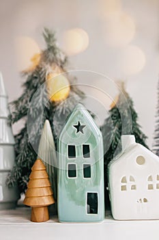 Christmas scene, miniature holiday village. Christmas lights, little houses, trees on white