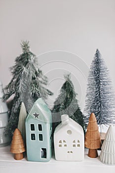 Christmas scene, miniature holiday village. Christmas little houses and trees on white background