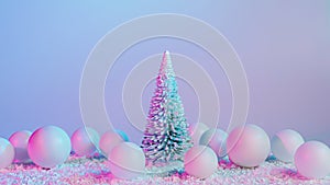Christmas scene with pine tree, decorative baubles and snow on iridescent neon background. Creative Xmas or New Year