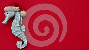 Christmas seahorse on red background
