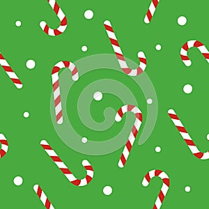Christmas seamless pattern with candy canes, snow ball on green background. Background for wrapping paper, fabric print