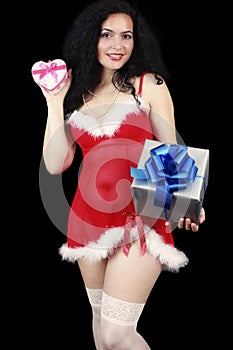 Christmas sensual brunette girl with gifts isolated on black