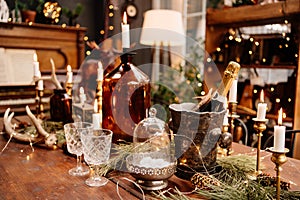 Christmas served wooden table with glasses, candles and champagne.