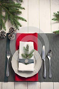 Christmas serving table. Traditional festive decoration background top view. Cutlery utensils beautiful plates decorative elements