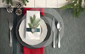 Christmas serving table. Traditional festive decoration background top view. Cutlery utensils beautiful plates decorative elements