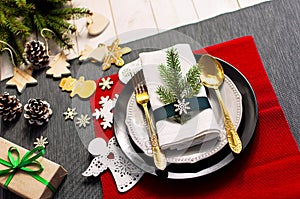 Christmas serving table. Traditional festive decoration background top view. Cutlery utensils beautiful plates decorative elements