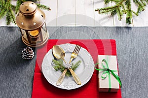 Christmas serving table. Traditional festive decoration background top view. Cutlery utensils beautiful plates decorative elements