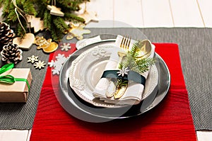 Christmas serving table. Traditional festive decoration background top view. Cutlery utensils beautiful plates decorative elements