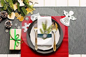 Christmas serving table. Traditional festive decoration background top view. Cutlery utensils beautiful plates decorative elements