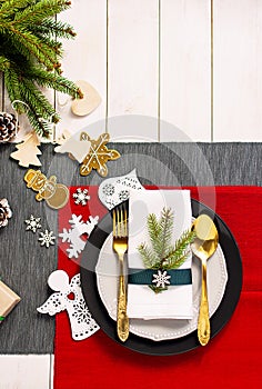 Christmas serving table. Traditional festive decoration background top view. Cutlery utensils beautiful plates decorative elements