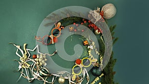Christmas set with many gold decorations, festive masks, balls on green background