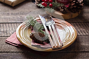 Christmas Setting Table. Dinner plate, silverware, fir tree, gift boxe, candle and festive decoration