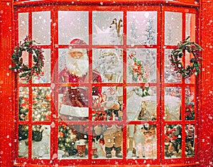 Christmas shop window with Santa Claus and christmas trees covered with snow