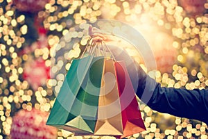 Christmas shopping bags in hand on christmas decoration9 photo