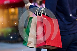 Christmas shopping - shopping bags in hand with snowflake photo