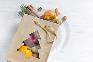 Christmas shopping for fruits, nuts and spices on blue background concept